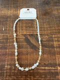Small white stones and gold necklace
